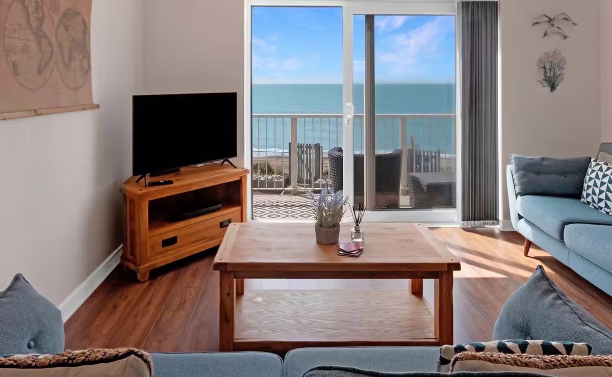 Venedotia – light-filled open-plan lounge with sliding doors to balcony
